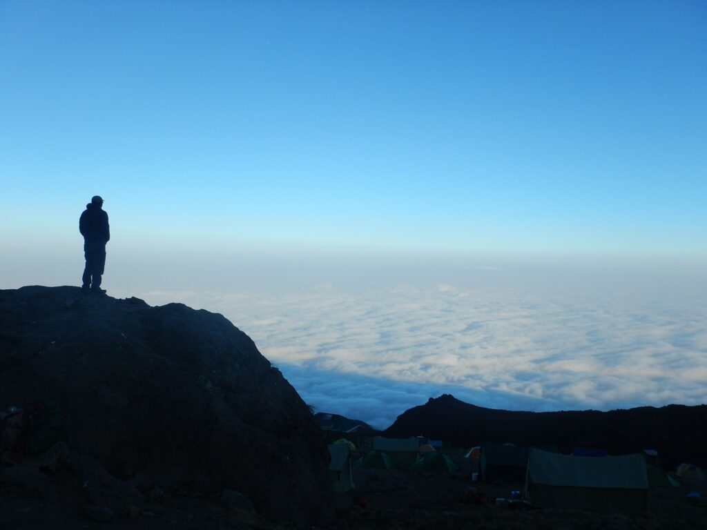 Man standing on the edge of a rock in a mountain